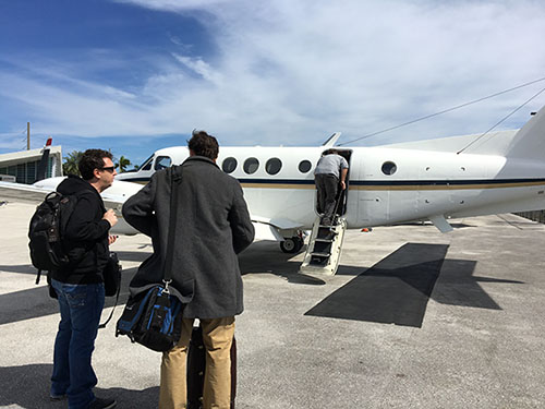 Media board a Guantanamo-bound plane in Miami.